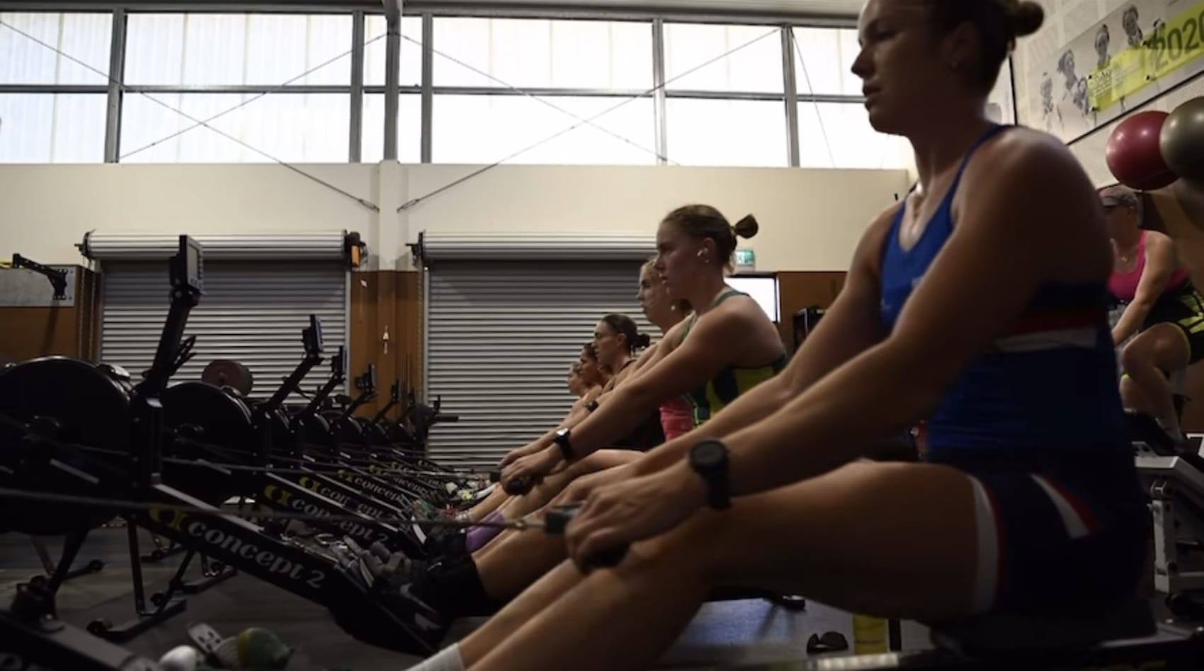 An athlete training hard on a Concept2 RowErg in a gym