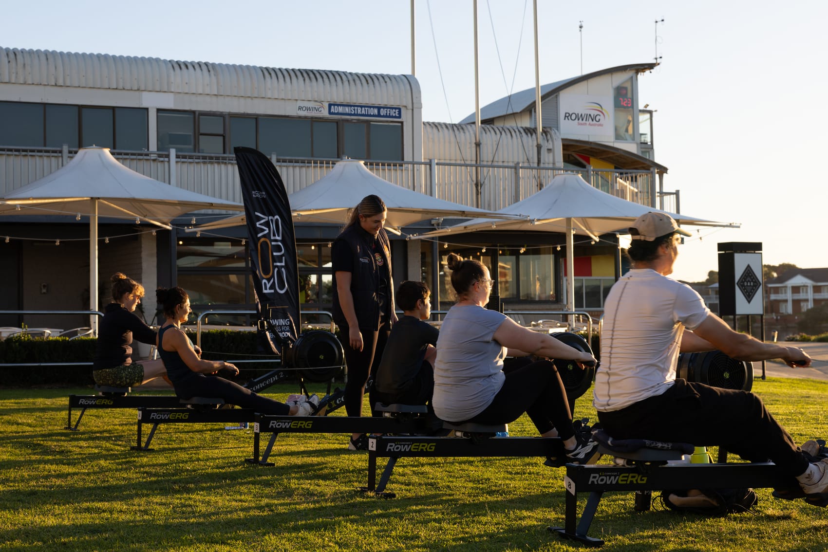 Row Nation coach guiding a group indoor rowing session on Concept2 RowErgs